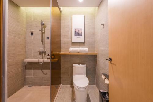 a bathroom with a toilet and a sink at Atour Hotel Beijing You'anmen West Tieying Subway Station in Beijing
