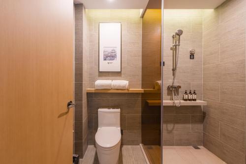 a bathroom with a toilet and a shower at Atour Hotel Beijing You'anmen West Tieying Subway Station in Beijing