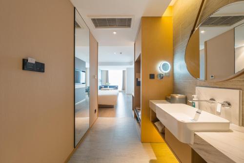 a bathroom with a sink and a mirror at Atour Hotel Beijing You'anmen West Tieying Subway Station in Beijing