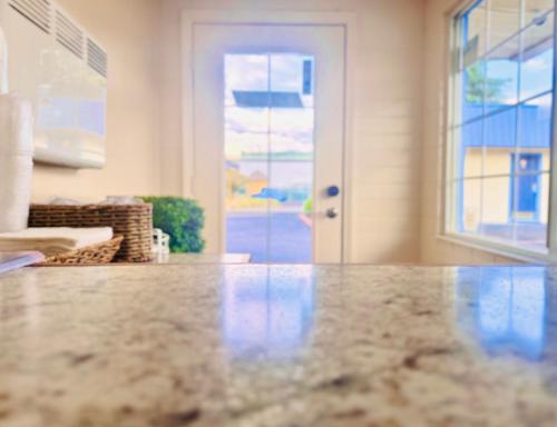 a kitchen with a marble counter top in front of a door at Relax Inn At Ashland in Ashland