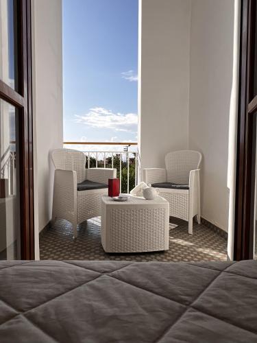 a bedroom with a bed and a table and chairs at Oasi Cuore in Castellammare di Stabia