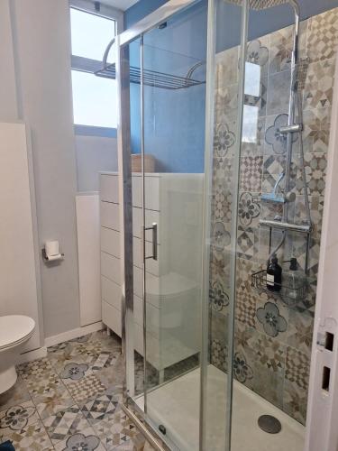 une douche avec une porte vitrée dans une salle de bain dans l'établissement Au Cœur du Cap d'Antibes pour 4 personnes, à Antibes