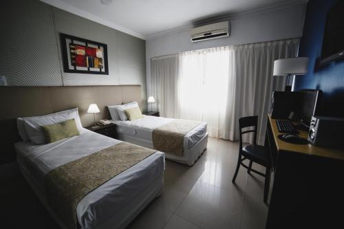 Ένα ή περισσότερα κρεβάτια σε δωμάτιο στο Ker Urquiza Hotel
