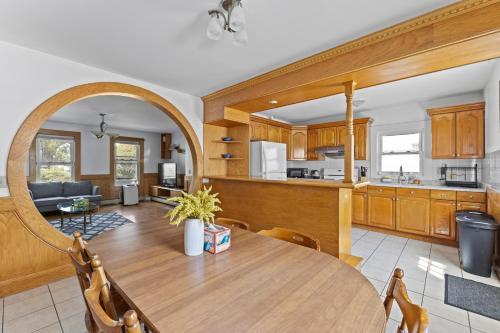 a kitchen and living room with a wooden table and chairs at 17 Cozy&Spacious 3 bedroom home in Malden with window AC in Malden