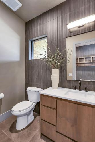 a bathroom with a toilet and a sink and a mirror at Violet Retreat in McCall