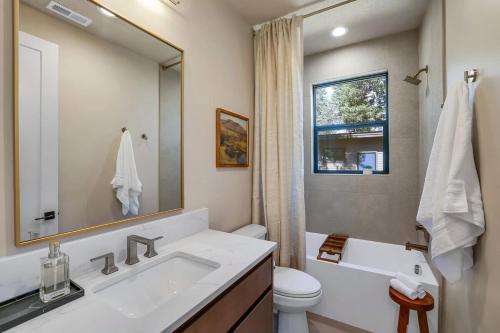 a bathroom with a sink and a toilet and a mirror at Violet Retreat in McCall
