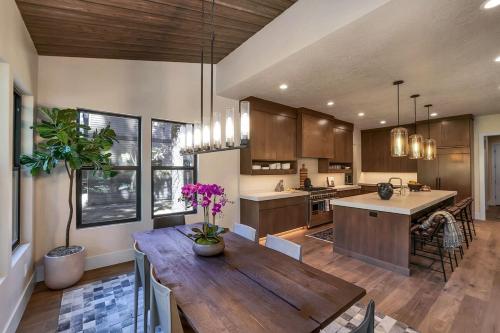 a large kitchen with a wooden table in a room at Violet Retreat in McCall