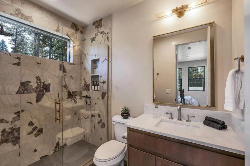 a bathroom with a toilet and a sink and a shower at Violet Retreat in McCall