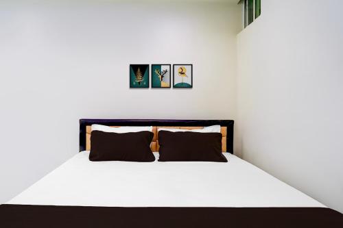 a bedroom with a white bed with two pillows at Hotel O The Silver Stone in Guwahati