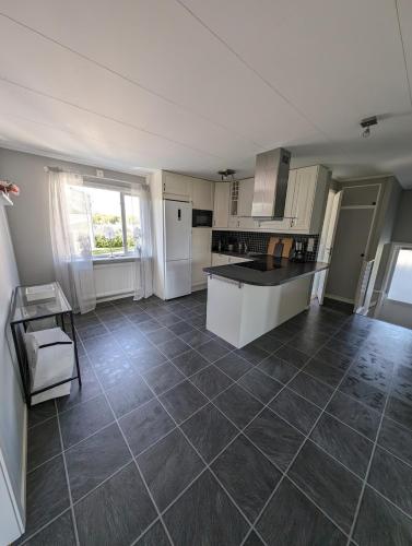 a kitchen with a tile floor and a counter top at Cozy countryside Appartment in Örebro