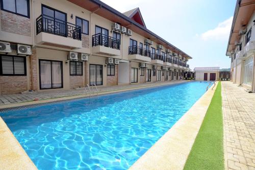 a swimming pool in the middle of a building at Dream Golftel by Dream Residences in Manolo Fortich