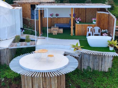 a backyard with a table and a bath tub at Monsaan ม่อนซาน in Mon Jam