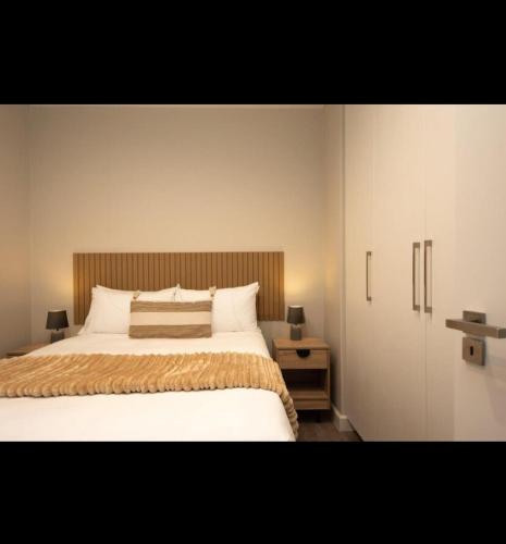 a bedroom with a large bed with a wooden headboard at The Cove in Vosburg