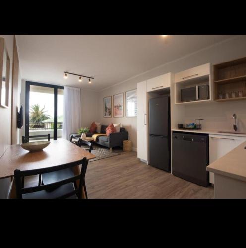 a kitchen and living room with a table and a couch at The Cove in Vosburg