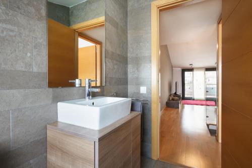 a bathroom with a white sink and a mirror at Matarolux 5 in Mataró