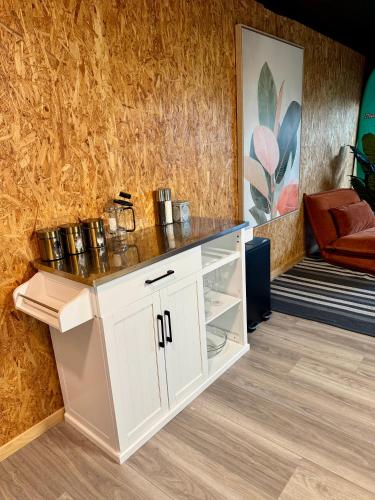 a white cabinet with a counter top in a room at Sandy Toes & Netflix Nights, Relaxing Auckland Retreat in Auckland