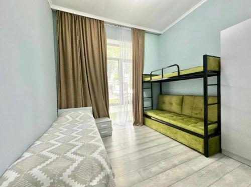 a bedroom with two bunk beds and a window at Atlantis in Akchiy
