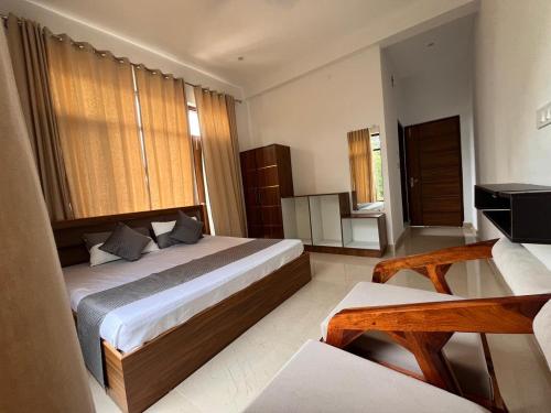 a bedroom with a large bed in a room at AeroVale Lodge in Bīr