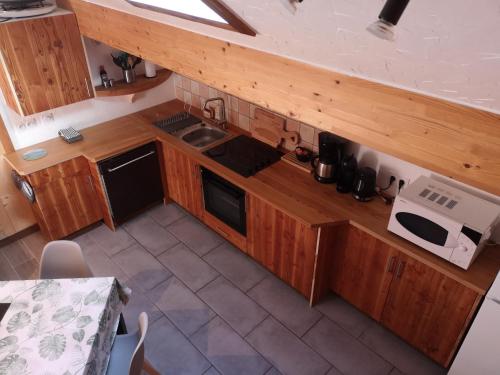 une vue aérienne d'une cuisine avec des armoires en bois dans l'établissement Appartement à la montagne, à Villar-dʼArêne