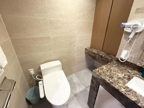 un baño con inodoro y lavabo en Mohenic Hotel Seoul Myeongdong, en Seúl