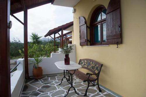 a patio with a table and a chair on a balcony at Elia Houses in Koutsounari