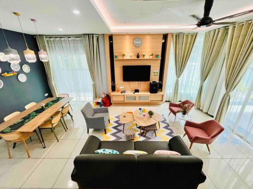 a living room with a couch and a table at Sunday Villa 14 pax with jacuzzi pool in Ulu Melaka