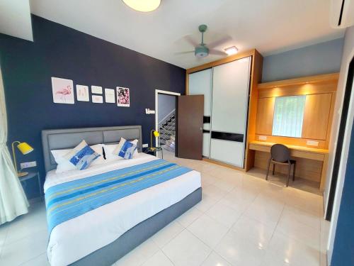 a bedroom with a large bed and a desk in it at Sunday Villa 14 pax with jacuzzi pool in Ulu Melaka