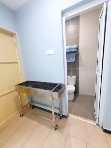 a bathroom with a sink and a toilet in it at Sunday Villa 14 pax with jacuzzi pool in Ulu Melaka