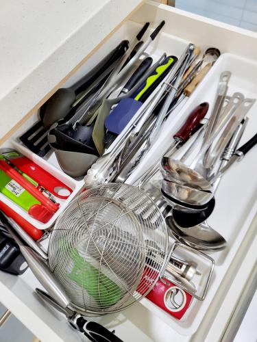 a drawer filled with kitchen utensils and a fan at Sunday Villa 14 pax with jacuzzi pool in Ulu Melaka
