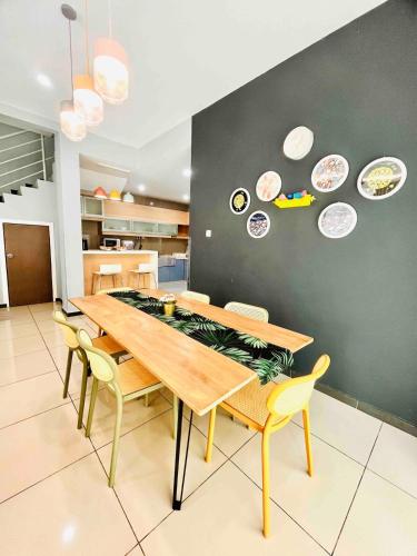 a dining room with a table and plates on the wall at Sunday Villa 14 pax with jacuzzi pool in Ulu Melaka