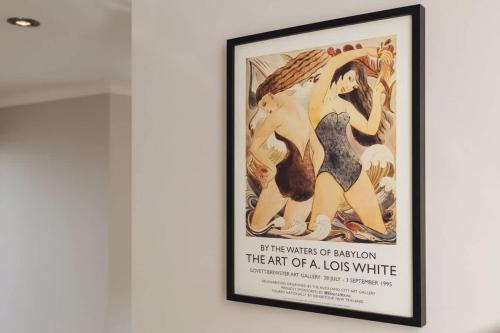 a framed painting of a mermaid on a wall at City Sails - 3 BR townhouse in central New Plymouth in New Plymouth