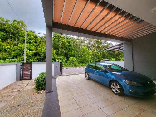 a blue car parked inside of a garage at Sunday Villa 14 pax with jacuzzi pool in Ulu Melaka