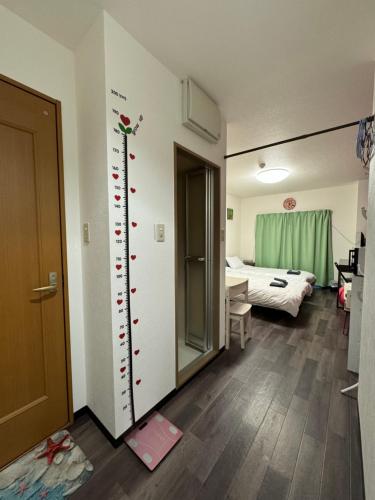 a room with a wall with red hearts on it at 華宝民泊1 in Osaka