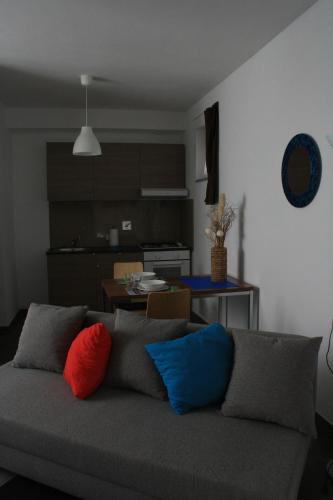 a living room with a couch with colorful pillows at TataBlu residenza con parcheggio in Florence