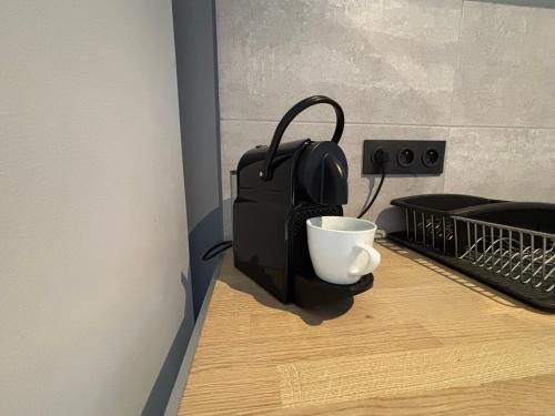 a black bag and a cup on a table at Aux 67 nuances - Spa in Châtenois