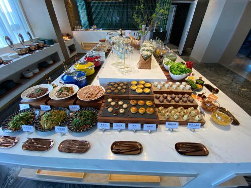 a table with many different types of food on it at Atour Hotel Beijing Hepingli UIBE in Beijing