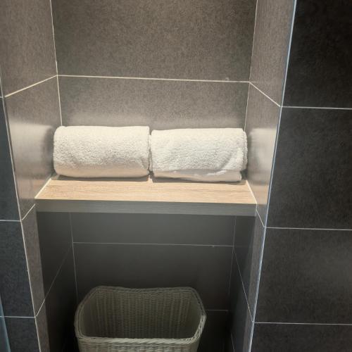 two towels are sitting on a shelf in a bathroom at Atour Hotel Xi'an Bell Tower North Street Station in Xi'an