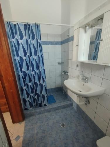 a bathroom with a sink and a shower at Trifyllianika Calm View in Trifilliánika