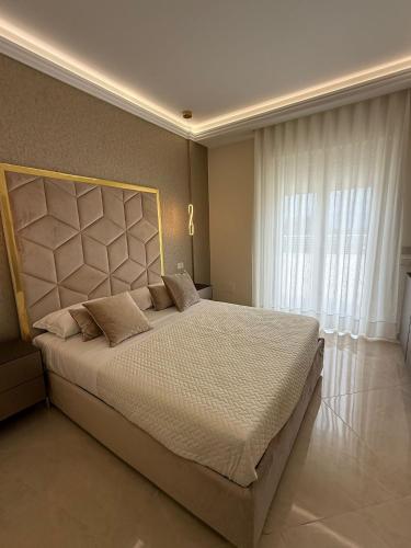 a bedroom with a large bed and a window at Amabile Luxury Rooms in SantʼAntonio Abate