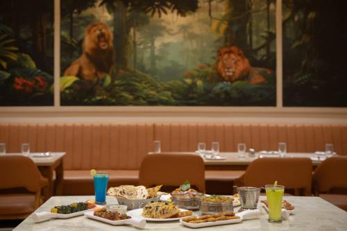 a table with plates of food on top at Gir Aatithya Clarks Inn in Sasan Gir