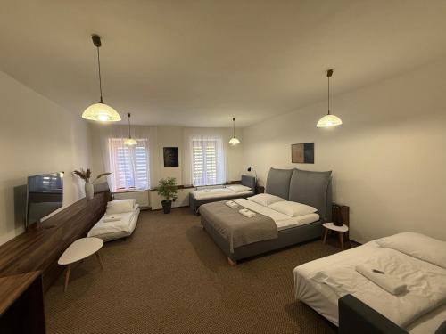 a living room with two beds and a couch at Penzión Max Kežmarok in Kežmarok
