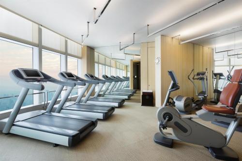 a gym with a row of treadmills and ellipticals at Park Hyatt Shanghai in Shanghai