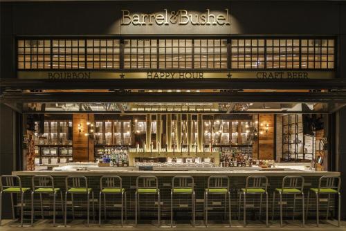 a bar with green chairs in front of a store at Hyatt Regency Tysons Corner Center in Tysons Corner