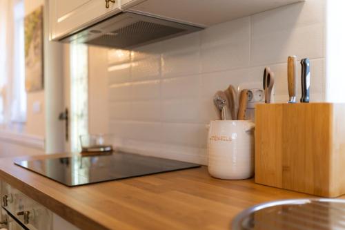 a kitchen counter with a knife block with utensils at Spa Garden Lounge in Mali Lošinj