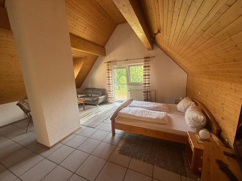 a bedroom with a large bed in an attic at Zum Kaiserwirt in Heppenheim an der Bergstrasse