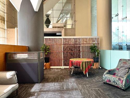 a room with a table and a chair and a tv at Hotel Maya Kuala Lumpur City Centre in Kuala Lumpur