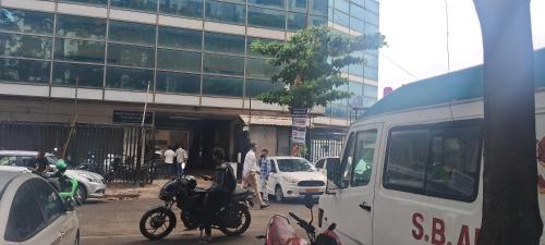 a street with cars and a motorcycle and a bus at Shine Hospitality Boutique Hotel in Mumbai