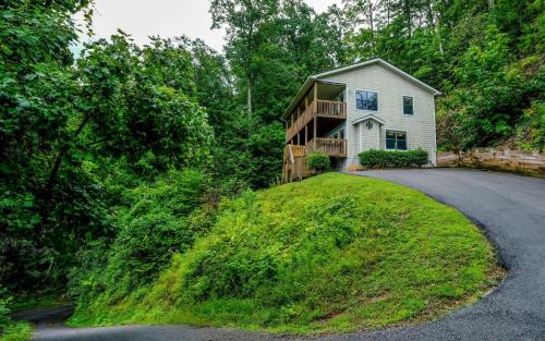 a house on a hill with a driveway at Among The Clouds 2240 in Gatlinburg