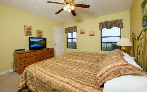 a bedroom with a bed and a flat screen tv at Among The Clouds 2240 in Gatlinburg