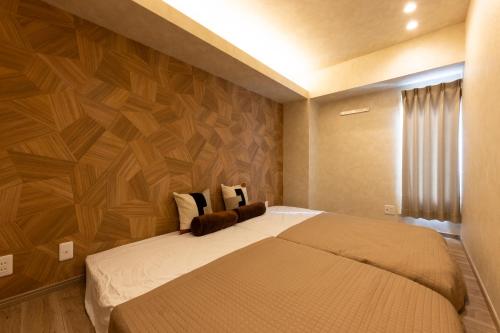 Postel nebo postele na pokoji v ubytování PREMIER suite Shinjuku West 3F 4F